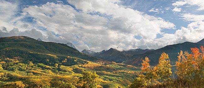 [© Capitol Retreat Panorama by Judy Hill is described with Capitol Peak, Colorado, Daly, Elk Range, Mt. Daly, Rockys, White River National Forest, Mountain, Mountains, 2005, Autumn, Fall, Rocky Mountains, Blue, Air, Alpine, Aspens, Blue sky, Brush, Clouds, Evergreen, Foliage, Leaf, Leaves, Pine, Pines, Green, golden, Beige, Gray, Neutrals, Warm, Yellows, White, Rocky, Tree, Trees, Woods, Fine Art, Stock, Color, Horizontal, Panorama hit 21098 rate ]